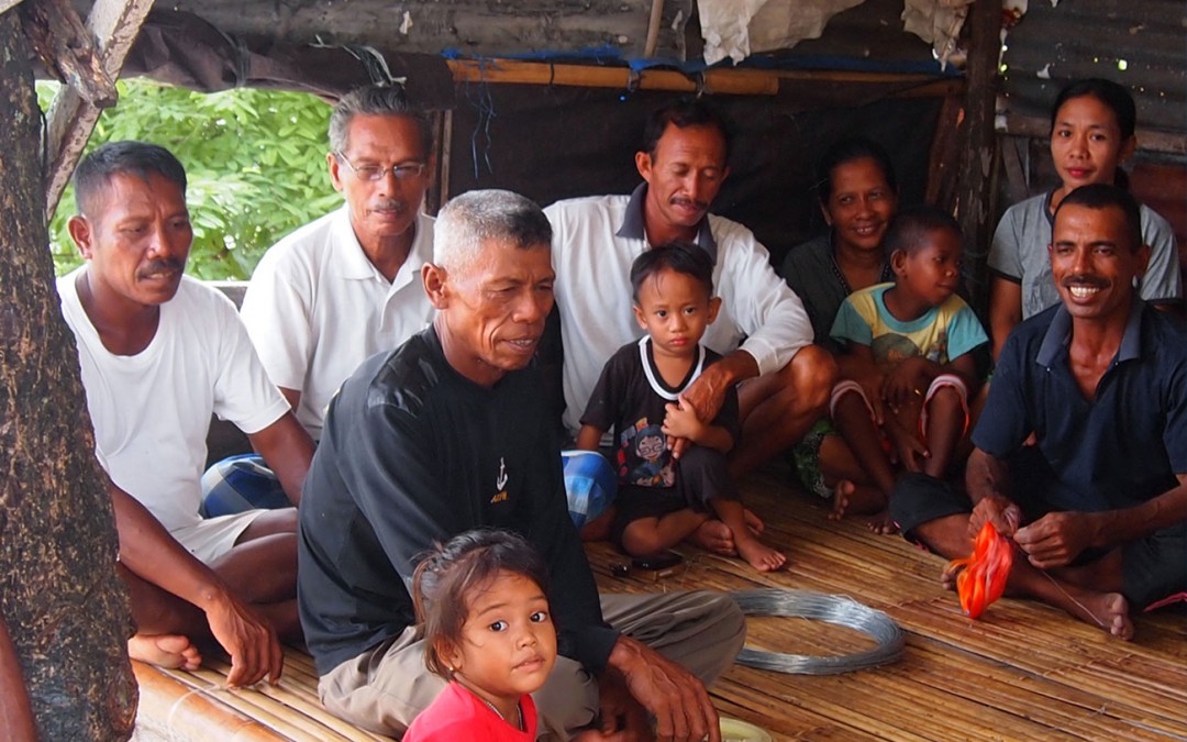 A group of fishermen and their families on the island of Tomia, in Sulawesi.