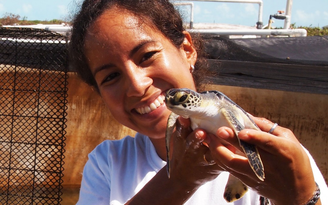 Eiglys Trejo holding one of 9 sea turtles she cared for and then released.